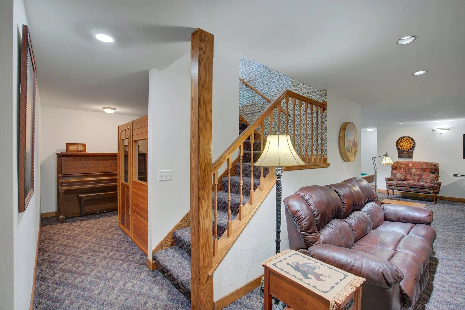 Family Room in Lower Level with hallway to storage rooms, mechanical rooms, and Fifth Bedroom and Bath