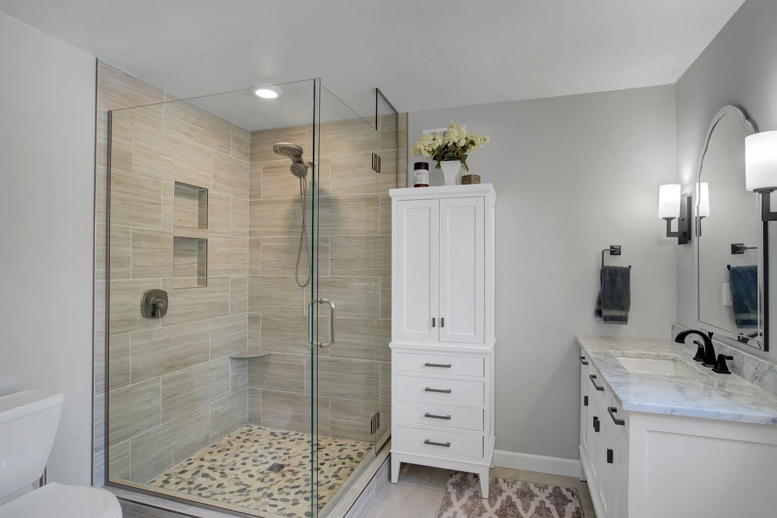 Renovated Primary Bath with double sink vanities, storage, and oversized custom shower