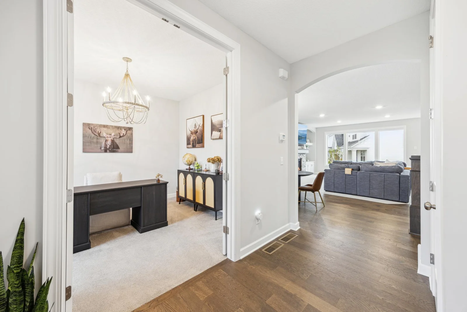 The office with french doors and showing the view into the living room area from the front door entrance.