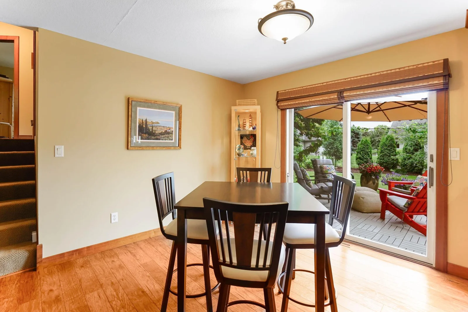 Relax in the dining area overlooking the low maintenance deck surrounded by graceful landscaping.