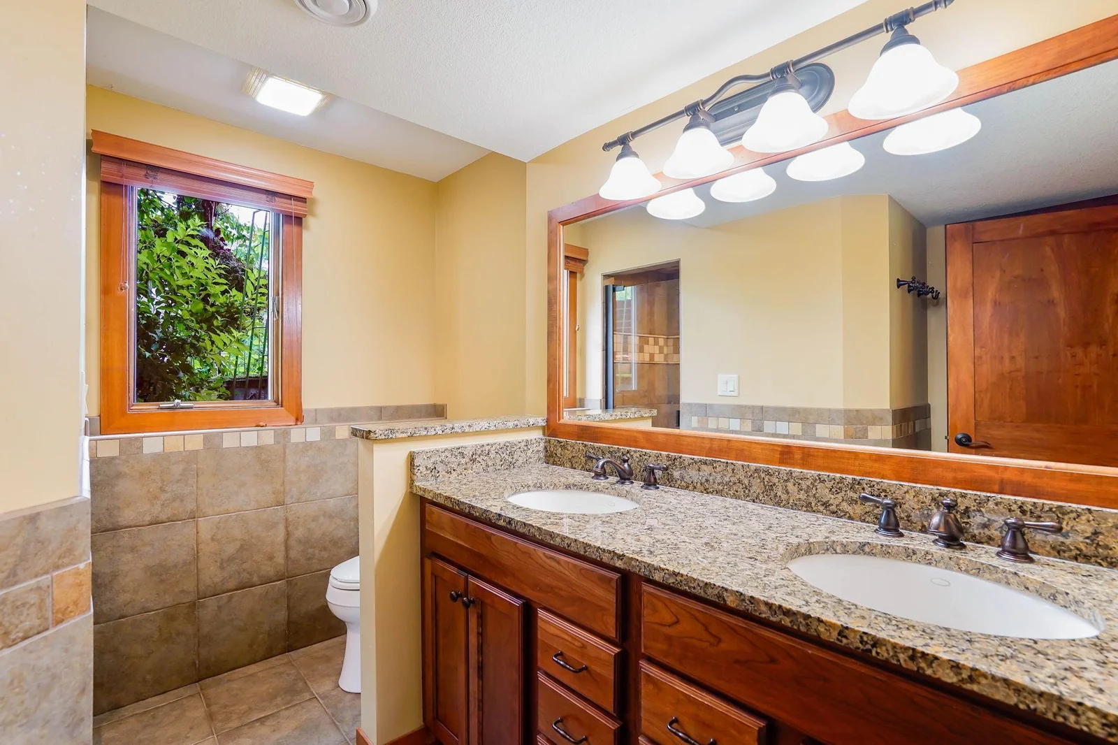 A dream bathroom incudes a double vanity granite floor and shower.