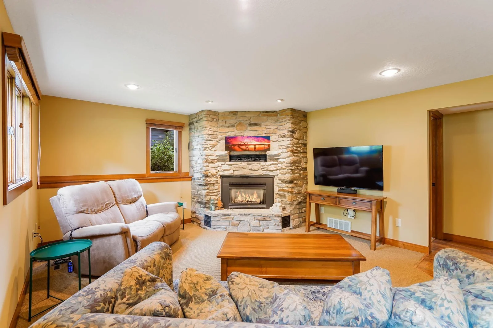 The gas fireplace is all stone, the carpet is high end and the can lights offer subtle light.