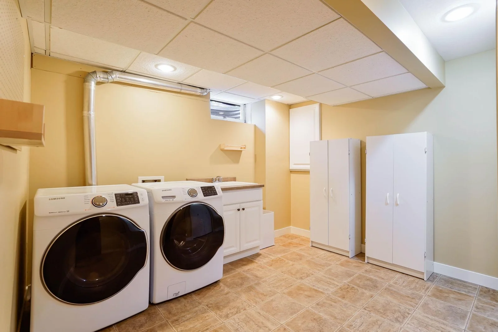 The laundry room is extra-large, includes a tile floor and a built-in laundry tub.