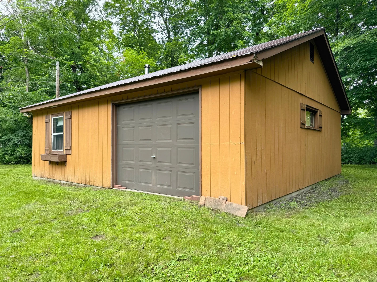 A shot of the exterior of the bunkhouse featuring the attached garage.