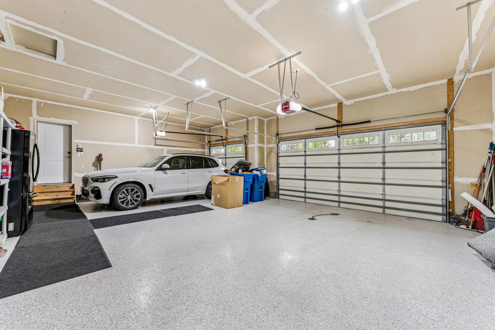 Large heated garage with epoxy flooring.