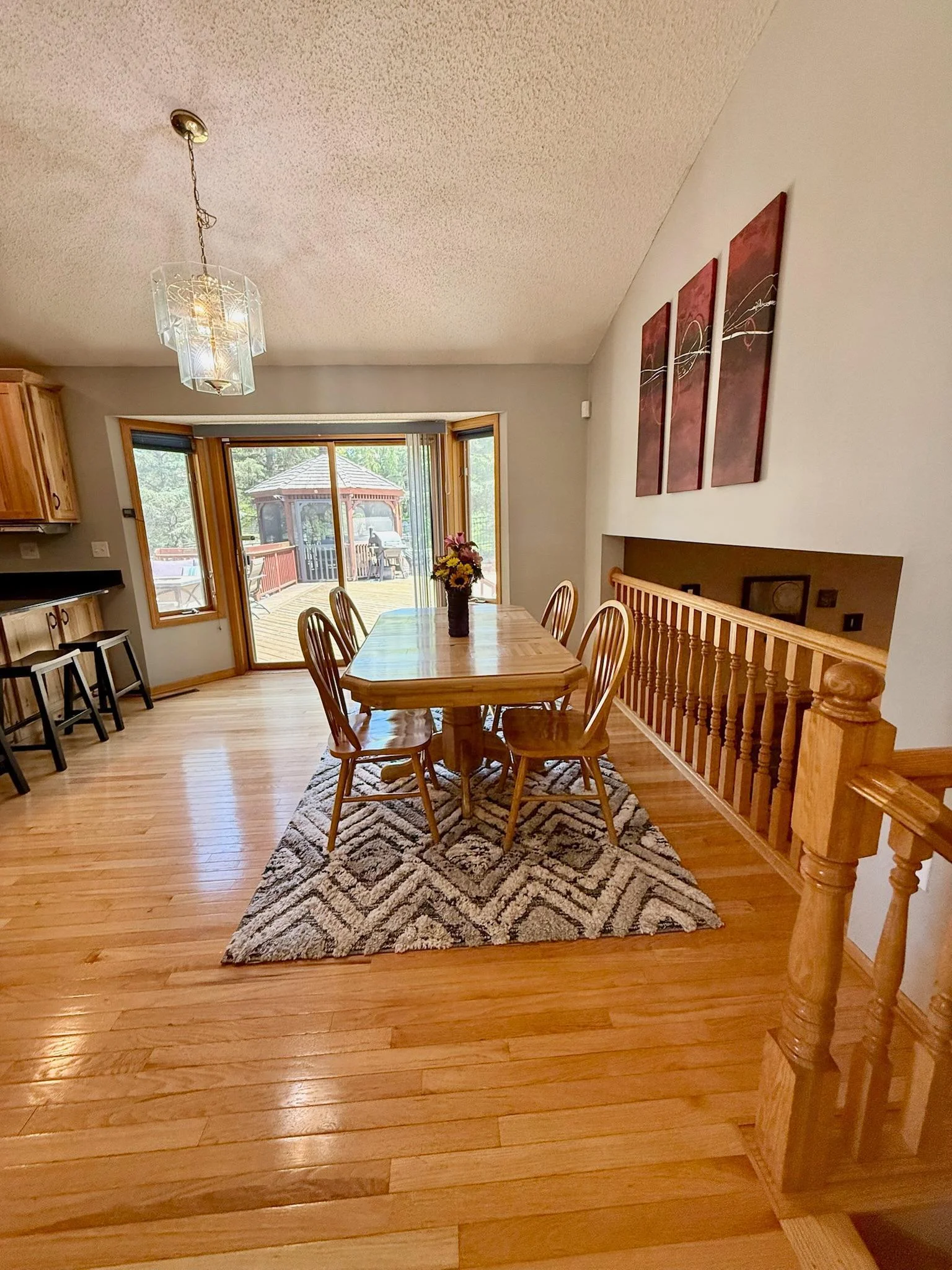 Informal separate dining room with patio doors leading to the large deck, gazebo and in-ground pool!!