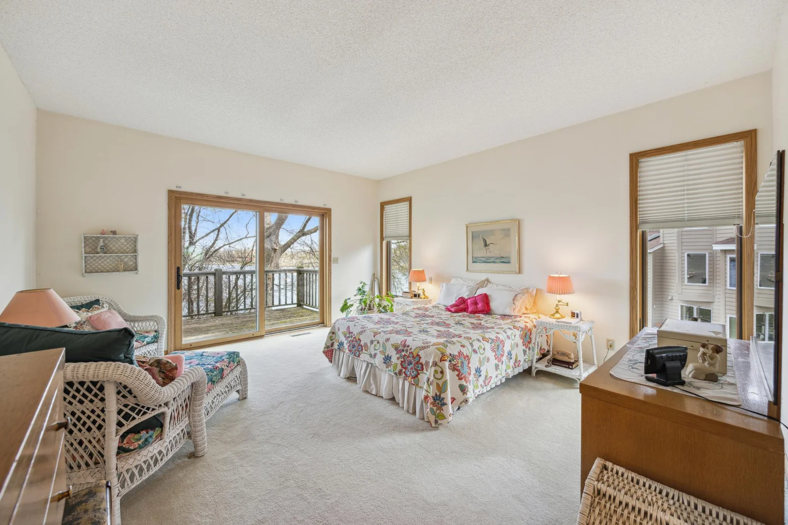 Mainfloor primary bedroom with sliding doors to deck.