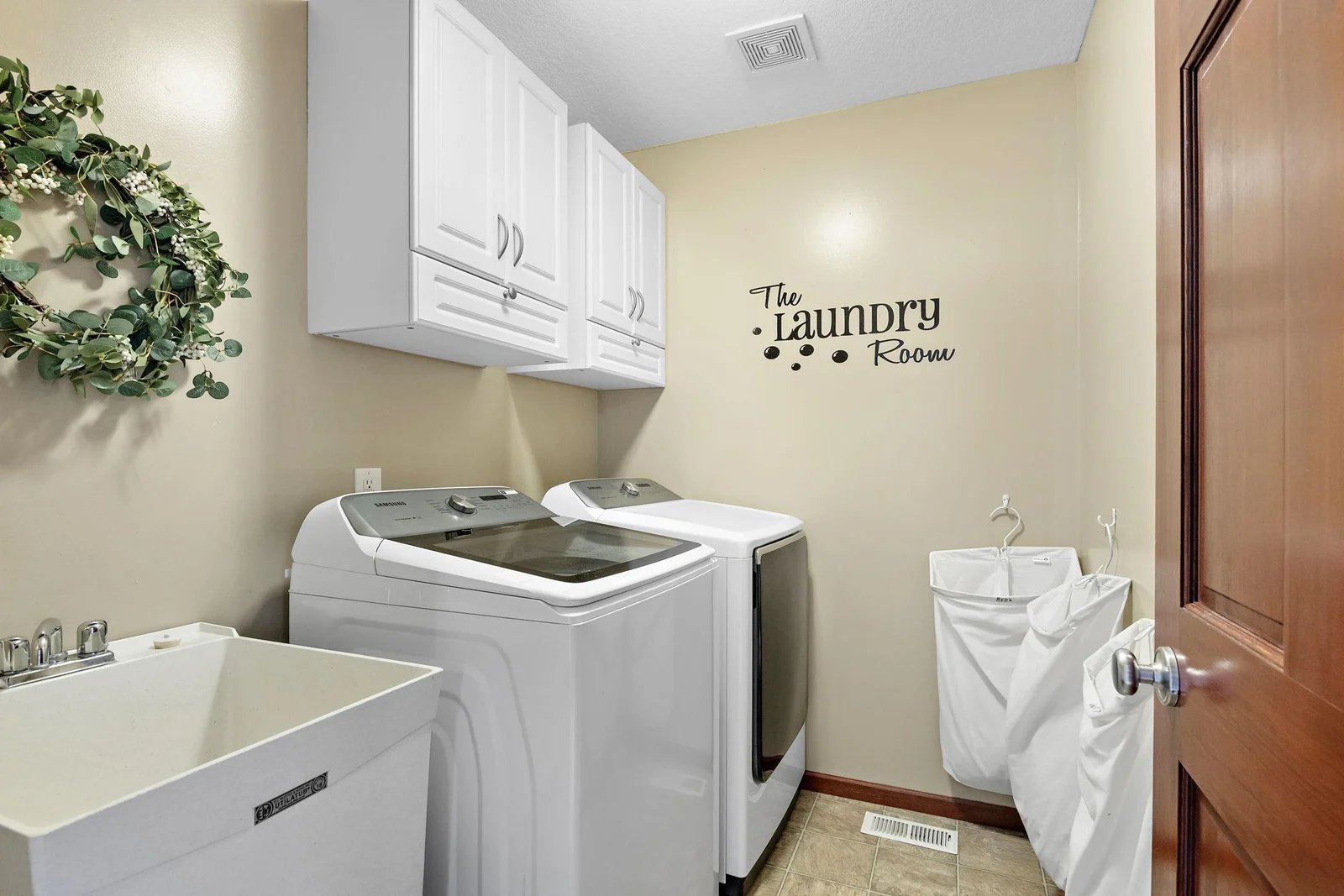 Upper Level Laundry with newer washer and dryer and utility sink!