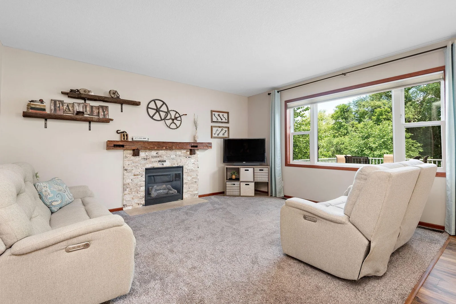 Large Living Room has Gas Fireplace with stone surround and beautiful hand hewn barnwood mantle!