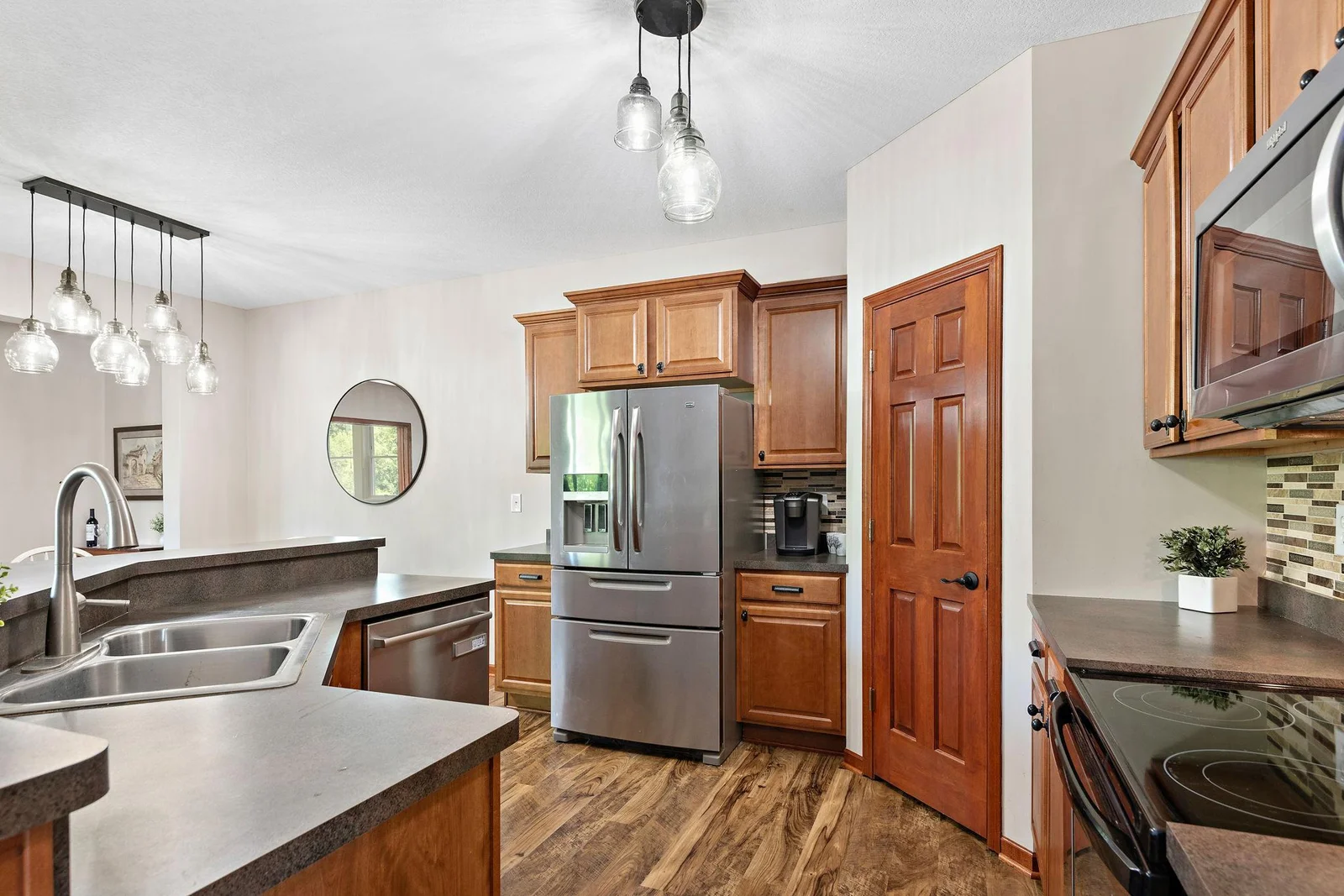 Center island with barnwood accent, tile backsplash and walk-in pantry!