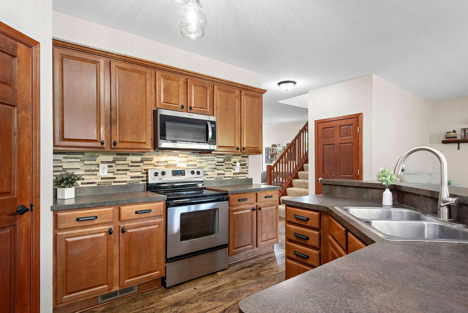 Huge Beautiful Kitchen that has a center island with barnwood accent, tile backsplash, High Breakfast Bar, walk-in pantry, stainless steel appliances - kitchen in open to Living Room, Dining Room and SunRoom Addition!
