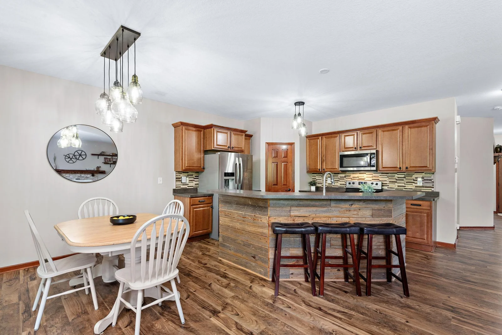 Huge Beautiful Kitchen that has a center island with barnwood accent, tile backsplash, High Breakfast Bar, walk-in pantry, stainless steel appliances - kitchen in open to Living Room, Dining Room and Sun Room Addition!