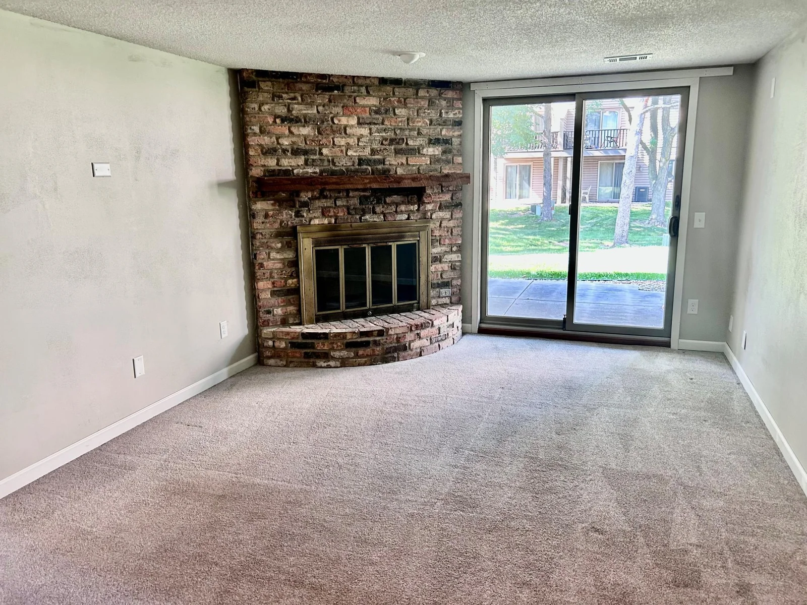 Lower level family room with fireplace and walk out to patio