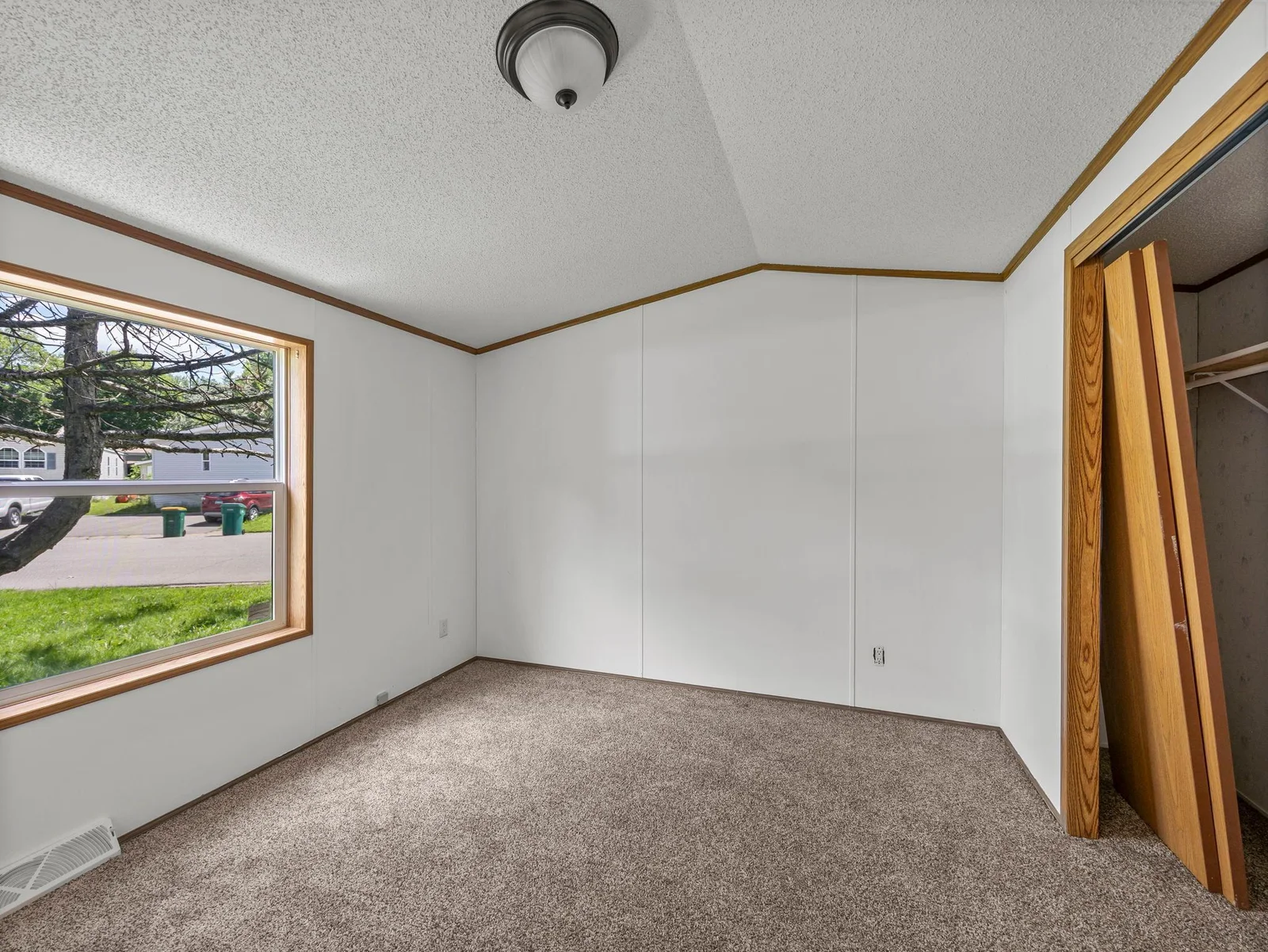 The primary bedroom features vaulted ceilings.
