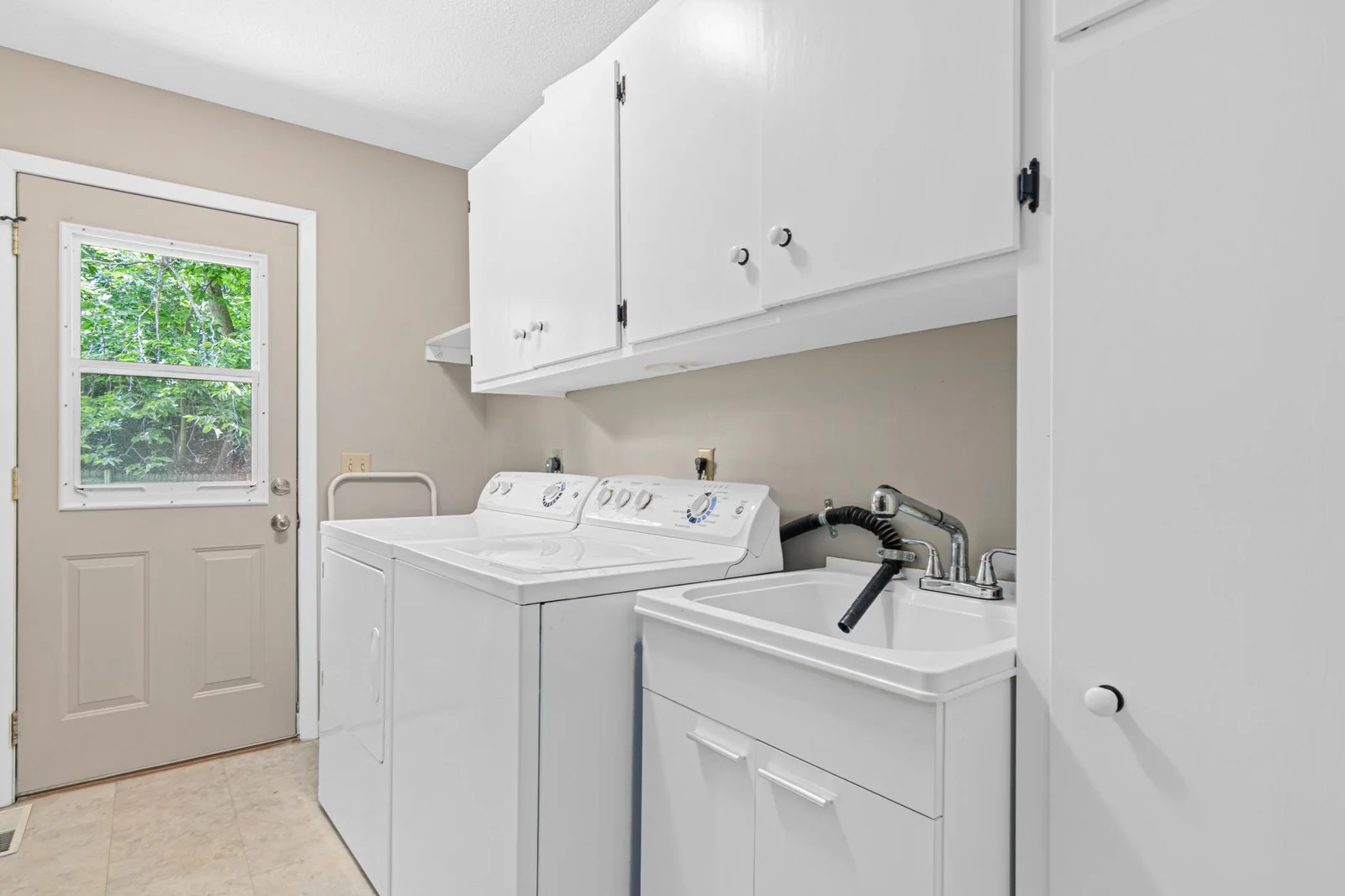 Spacious Upper Level Laundry Room With Backyard Access!
