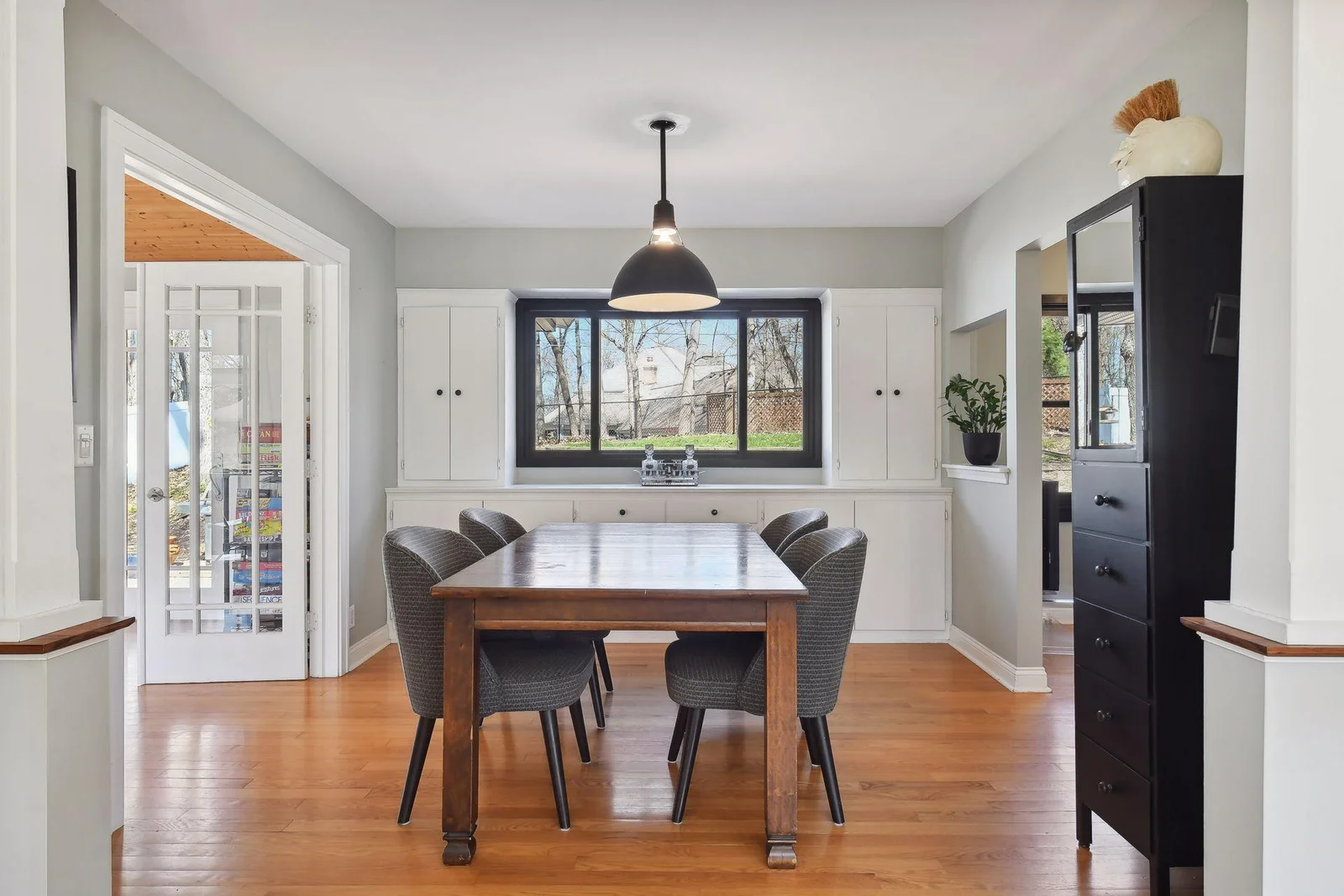 Dining room with built-in cabinets for storage