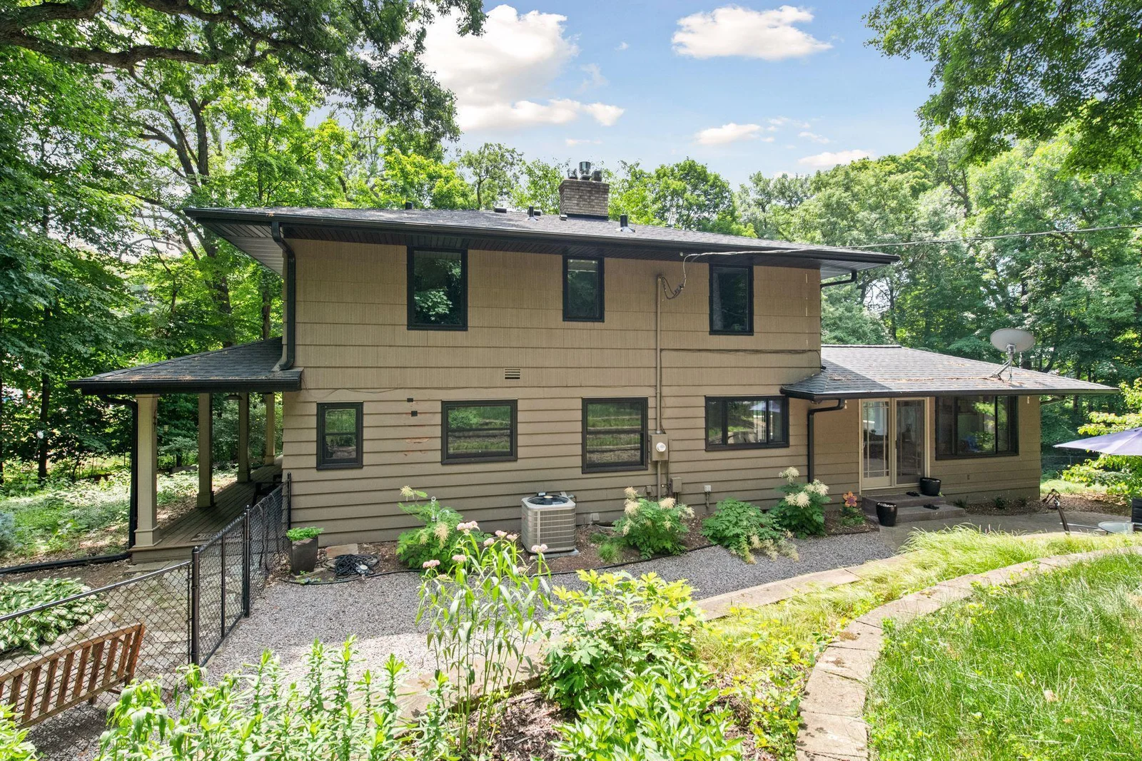 Wrap-around porch leads to the back yard (new fence in 2018)