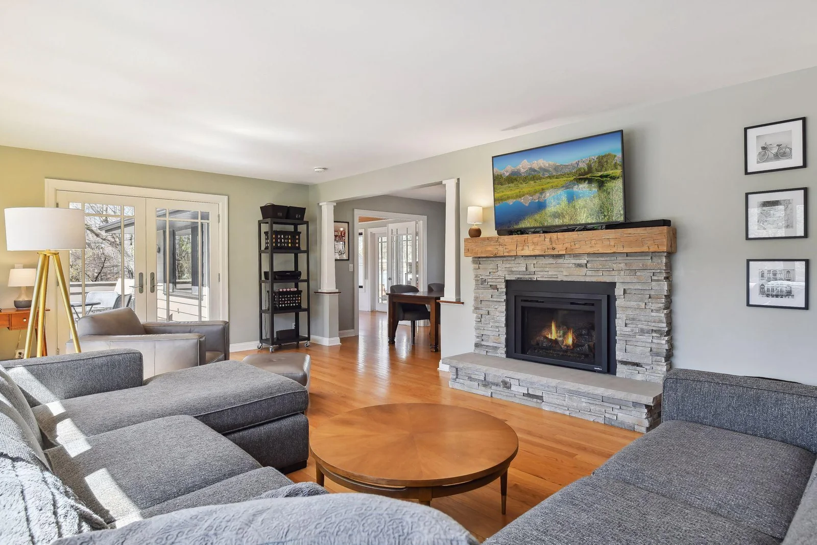 Hardwood floors, gas fireplace (new in 2022), and access to the porch are additional highlights of this space