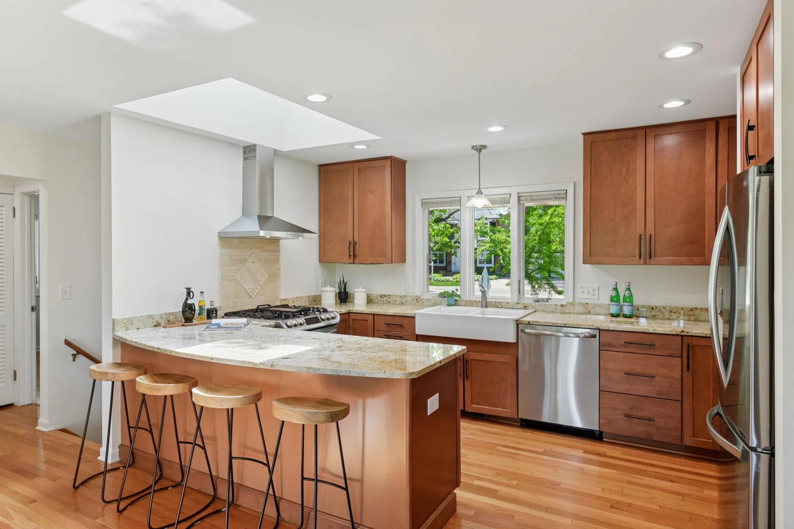 Updated stylish kitchen with granite counter tops and eat in peninsula