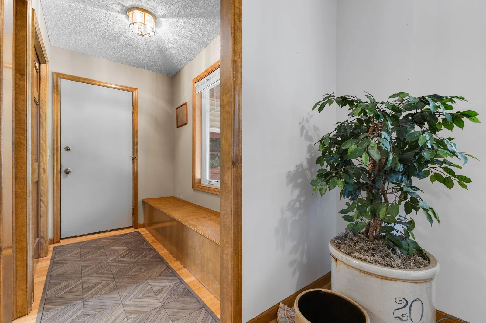 Mudroom with bench storage and large coat closet