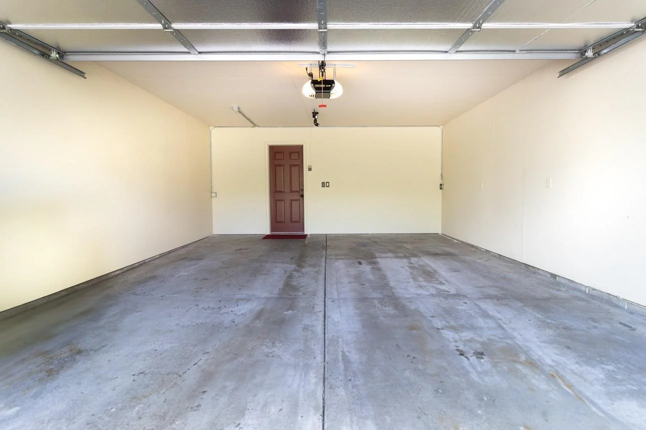 Finished Garage with insulated garage door and freshly painted walls & ceiling