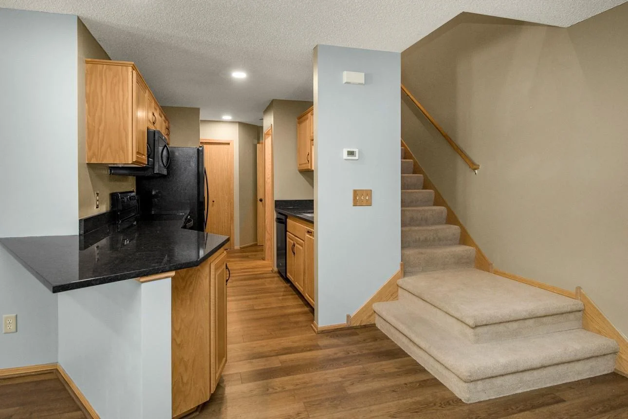 Upgraded kitchen with newer appliances, granite countertops, sink and disposal