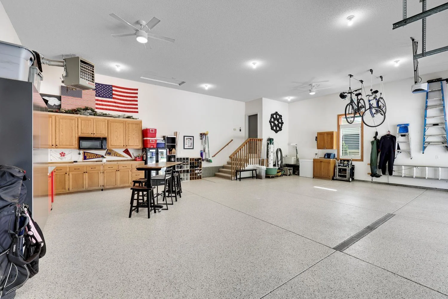 Three car garage that has ceiling access point for large full height storage area above the garage.