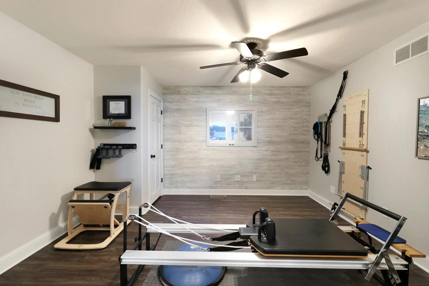 Exercise studio, office, or flex room has vinyl plank flooring, French doors, and oversized storage closet - equipment to be removed
