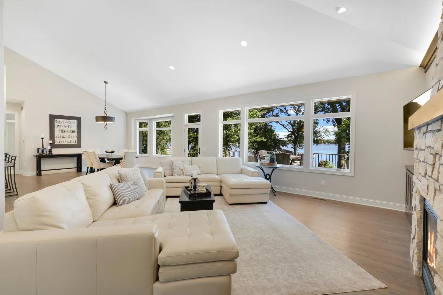 Full wall of windows and volume ceilings make the best of the views to the lake
