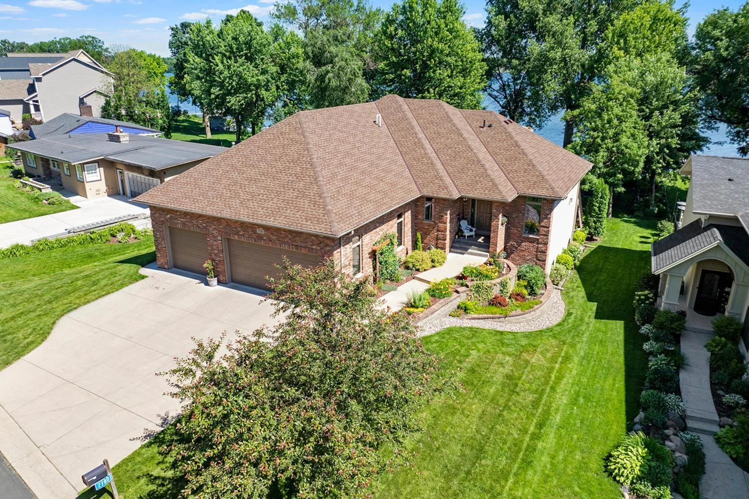 Handsome brick executive rambler with manicured lawn and gardens