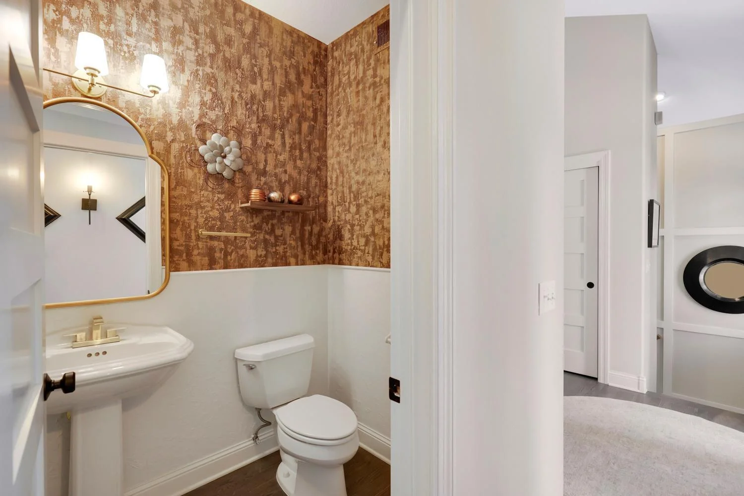 Powder room is conveniently tucked off the mud room and foyer