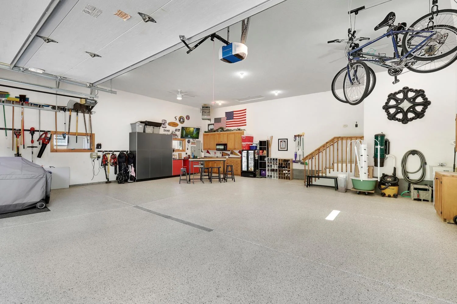 Garage has drywall finish, epoxied floors and is fully heated with four windows and room for 4-5 cars! In floor drain. True mancave on the lake!