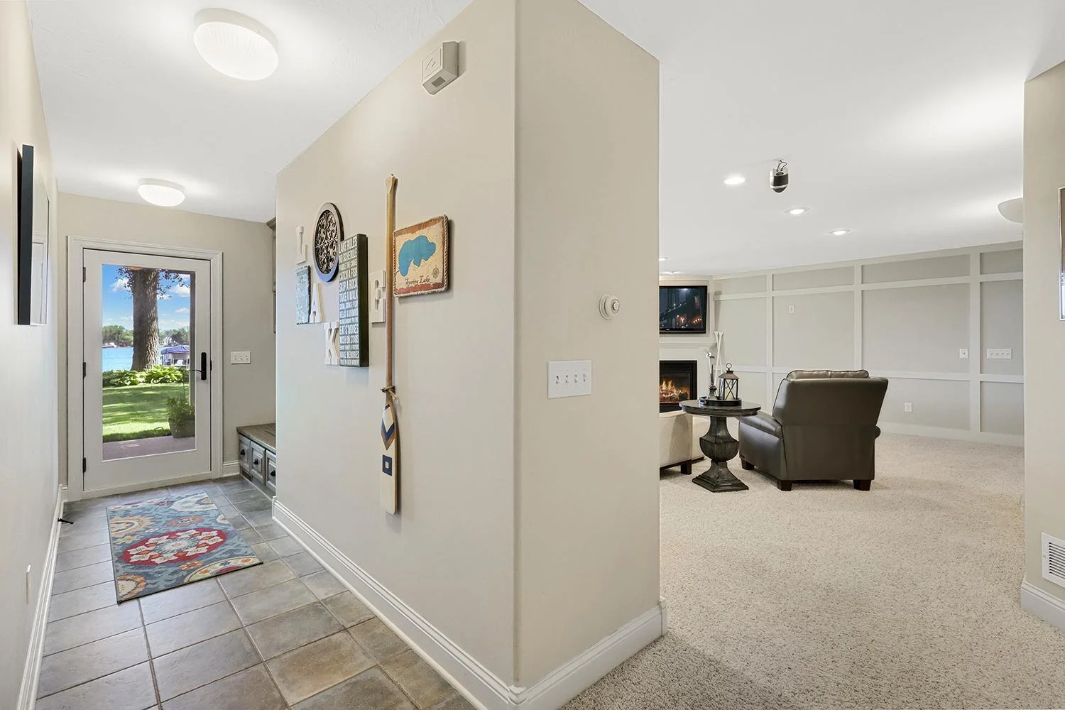 Lower-level walkout with second mudroom area and ceramic floors accesses the lakeside patio