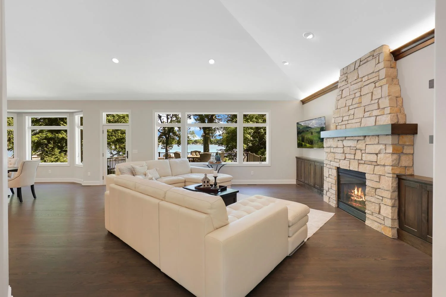 Custom stone fireplace with custom alder built-ins, mantel accent lighting and floating shelves