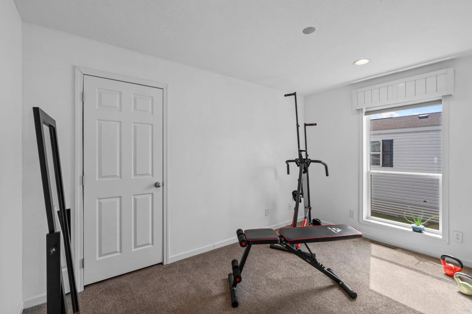 Two additional bedrooms are thoughtfully positioned on the opposite side of the home. Both feature soft carpeting and versatile layouts—perfect for use as guest rooms, home offices, or creative spaces like a workout room or hobby area.
