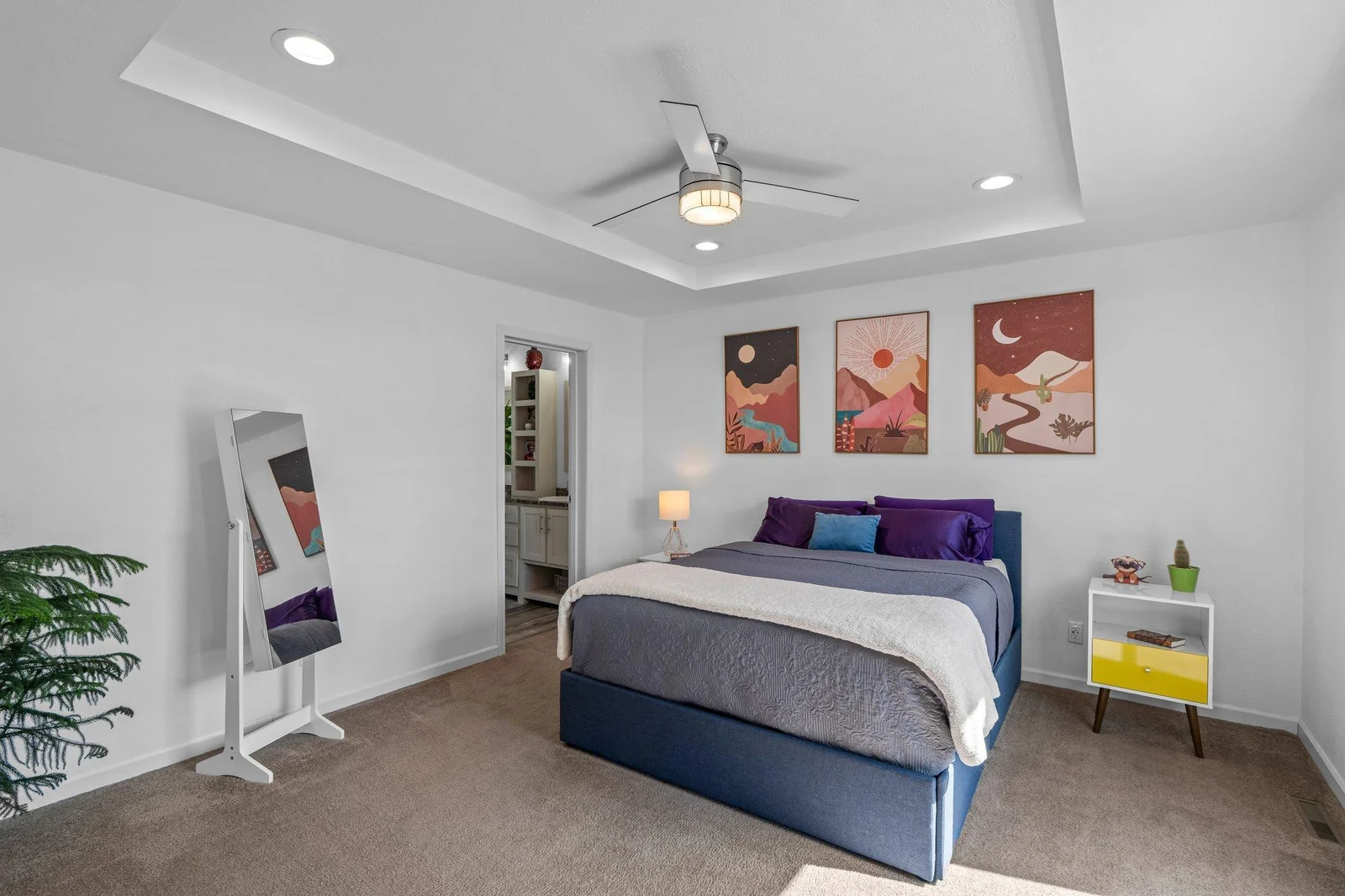 The spacious primary suite is tucked away for added privacy and relaxation. It boasts a tray ceiling, ceiling fan, and an oversized 8x6 walk-in closet offering excellent storage.