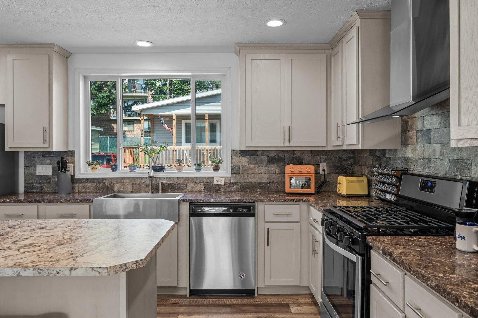 The living area flows seamlessly into a beautiful kitchen that will delight any home chef. Highlights include LVP flooring, stainless steel appliances, sleek countertops, and a stylish tile backsplash.
