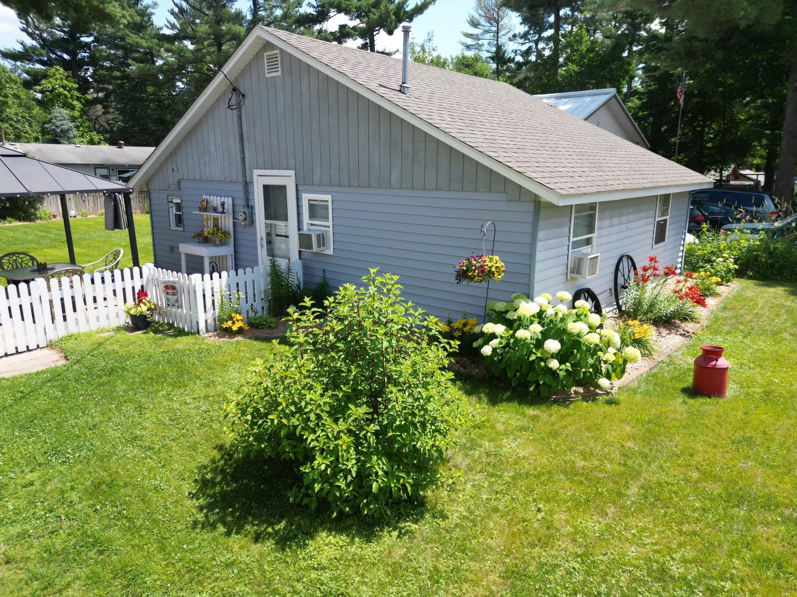 White picket fence and decorative landscaping