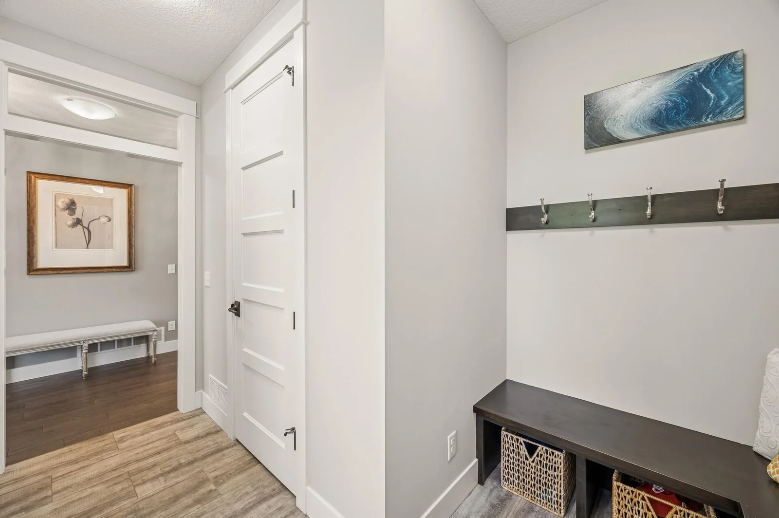 Mud room entry from the garage with large storage closet and bench seats
