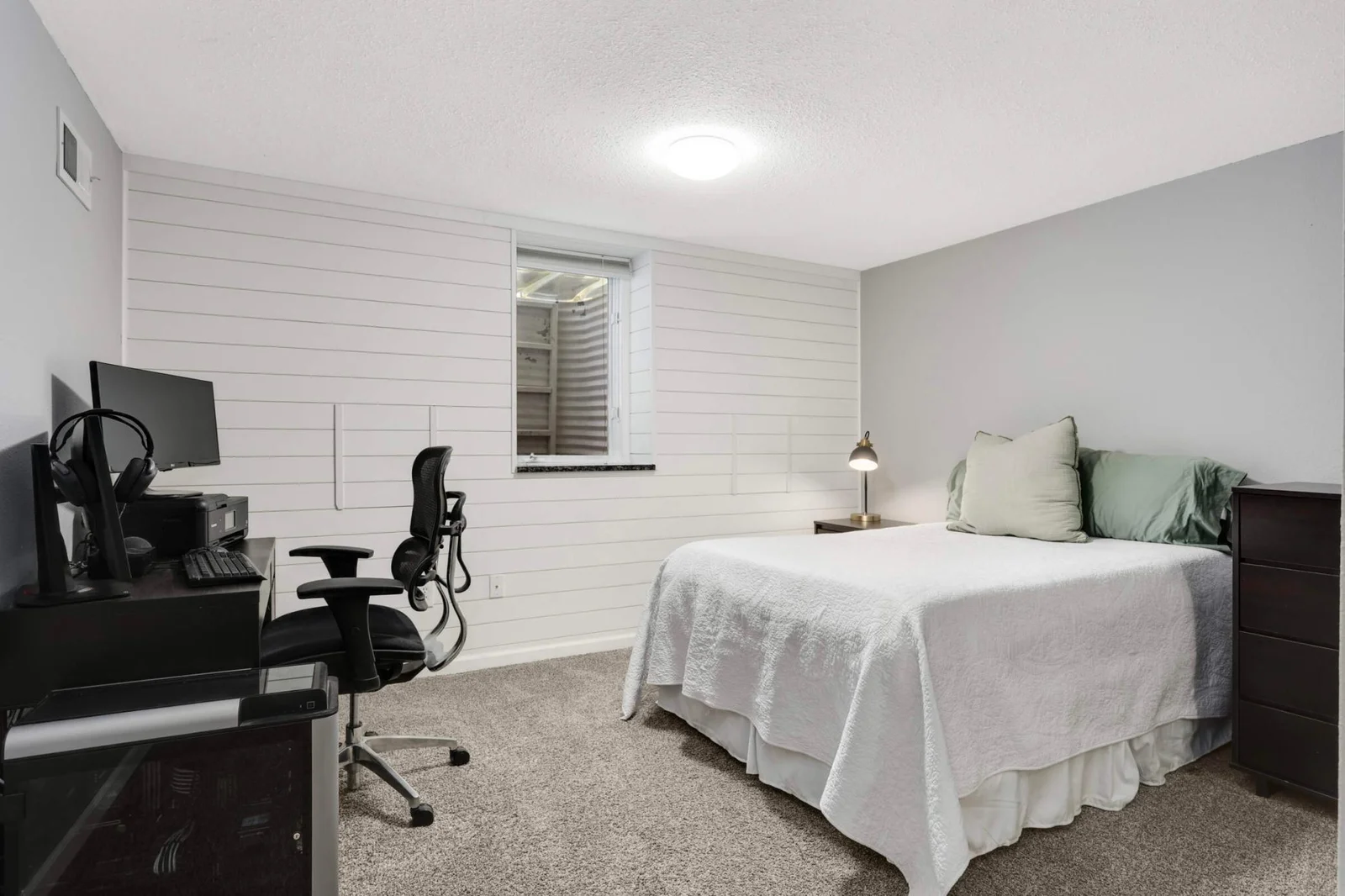 Lower level bedroom/home office with newly finished ship lap wall.