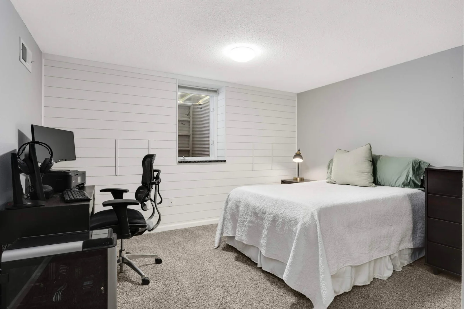 Lower level bedroom/home office with newly finished ship lap wall.