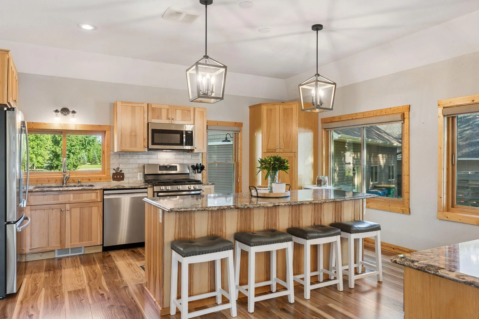Updated kitchen with Hickory cabinetry with stylish