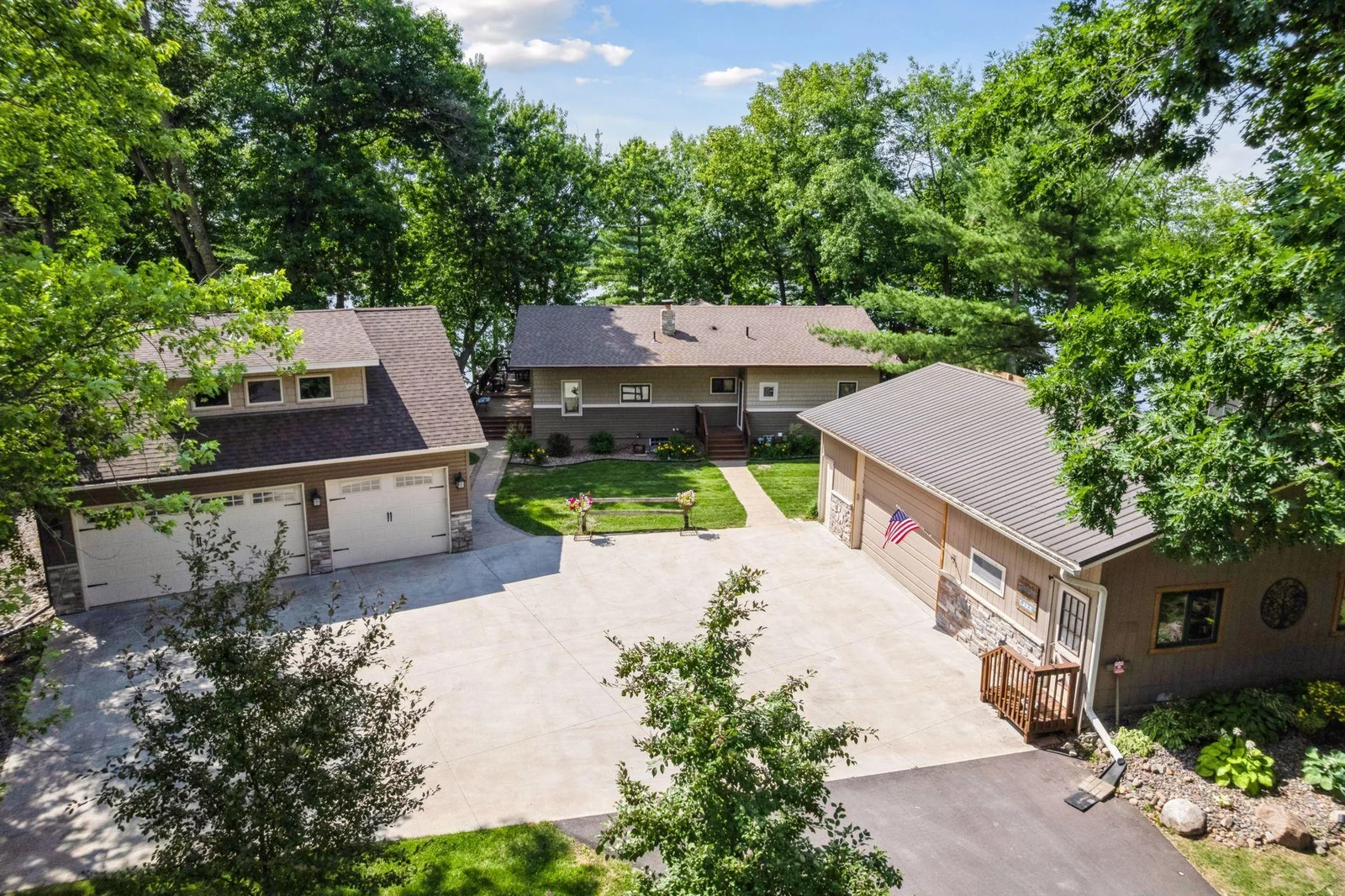 Secluded property that offers ample storage, newer garage with finished space and additional shop