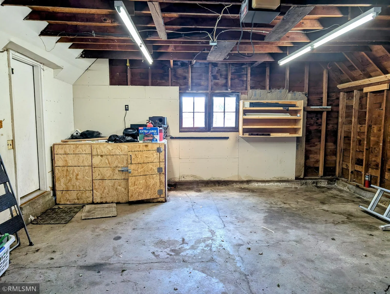 Garage with kennel in back corner that leads out to the outside kennel