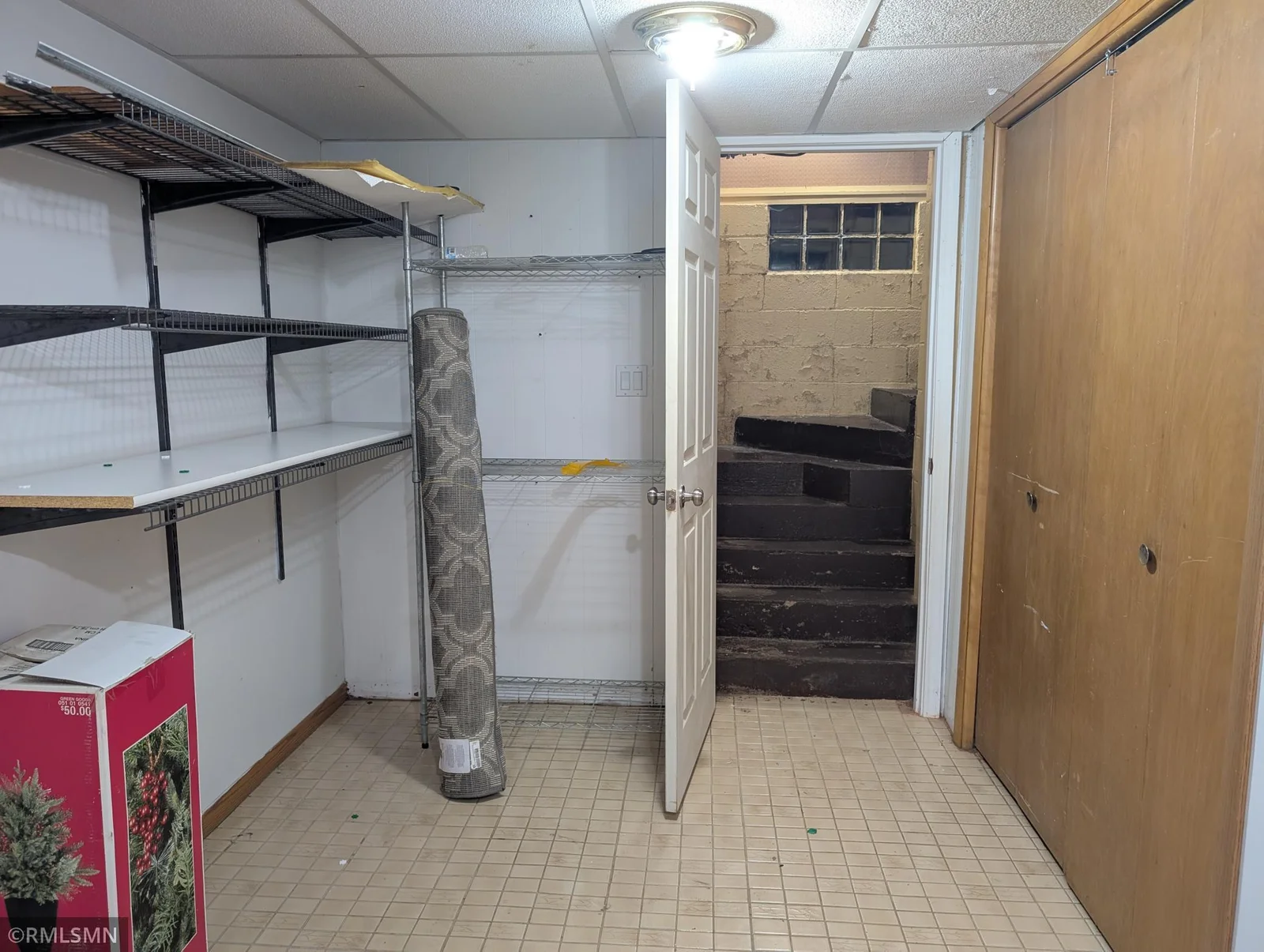 Laundry room has utility closet, sink, storage shelves and 2nd stair case leading to the breezeway