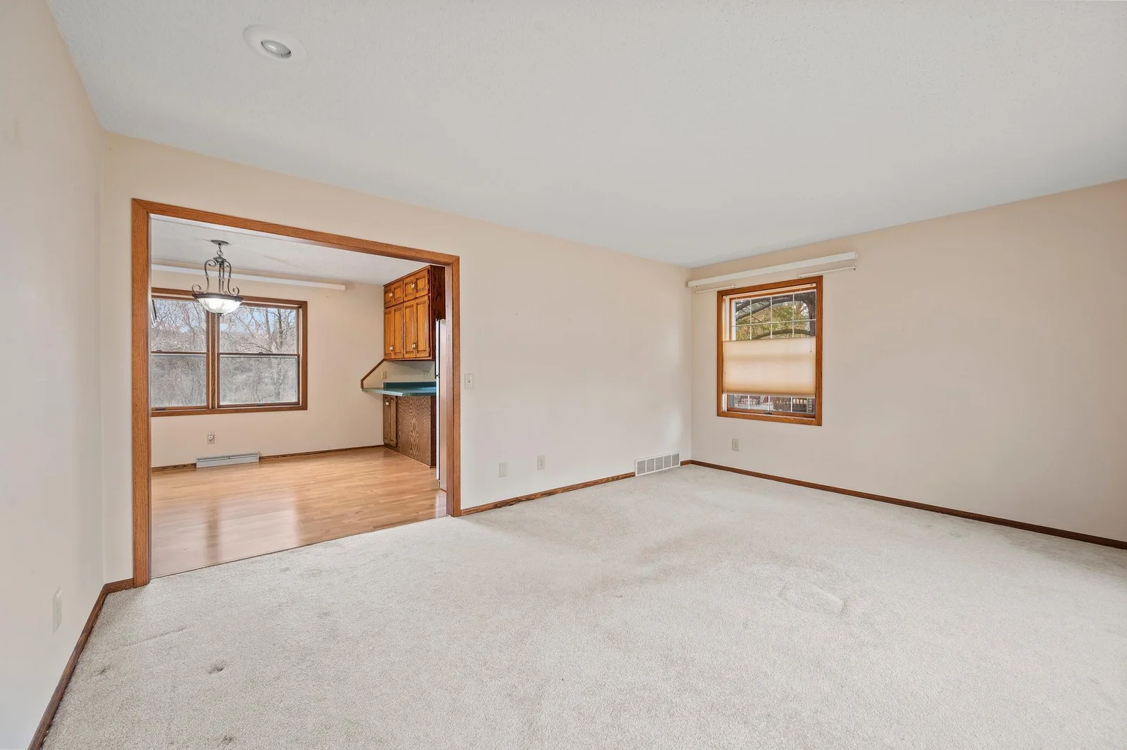 The main floor living room (one of two large rooms to relax in on the main level) is just off the dining area.