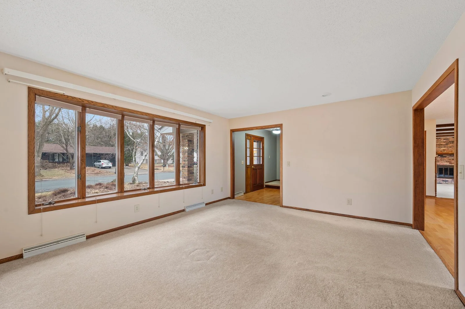 Large windows at the front of the home fill this spacious living room with light!
