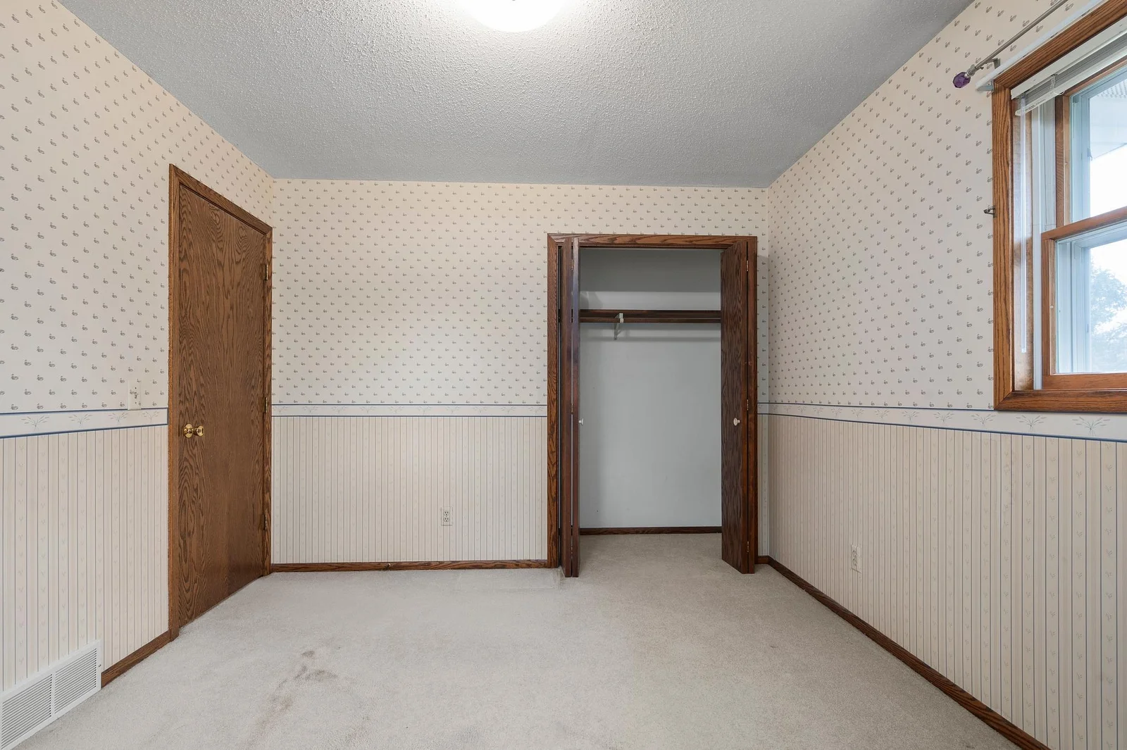 Closet and entrance of the second upper level bedroom just steps from the guest bathroom on the upper floor.