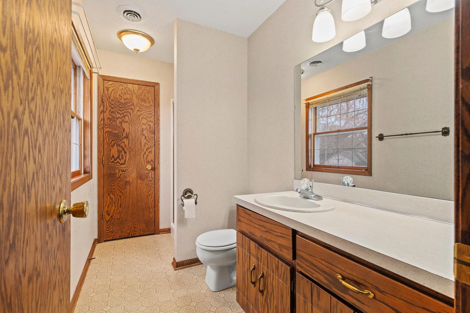 Private primary bathroom with shower and a window - this home is filled with light!