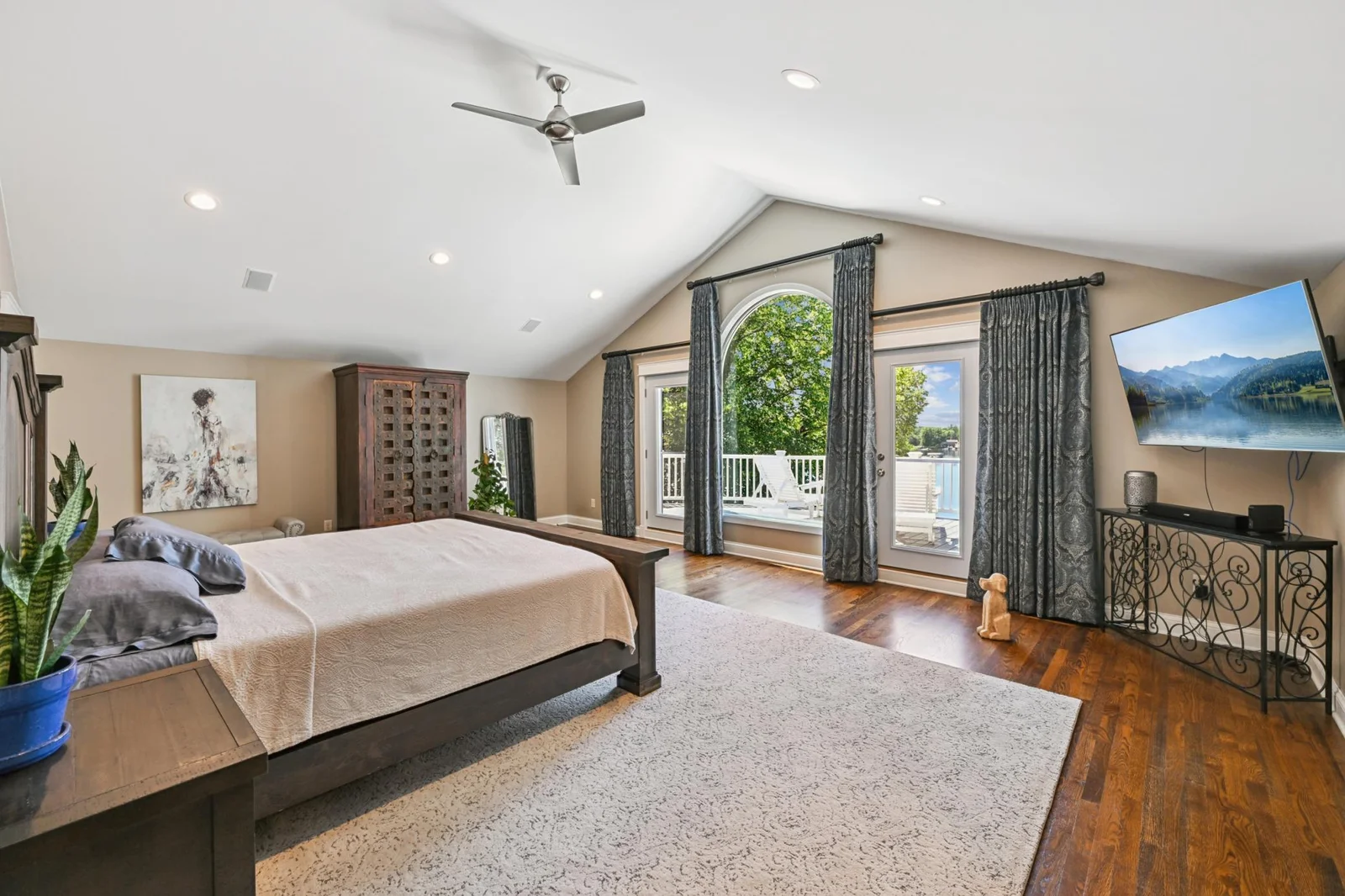 The spacious primary suite offers nearly 800 sq ft with vaulted ceilings, stunning lake views, a walk-through closet, and a luxurious spa-like bath with separate tub and shower.